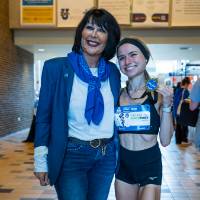 President Mantella posing with student after the Family Weekend Fund Run.